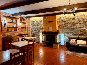 a living room with a couch and a fireplace at Hostal El Horno in Molinaseca
