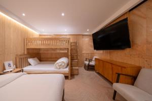 a bedroom with two bunk beds and a flat screen tv at Dongdaemun Signature Tourist Hotel in Seoul