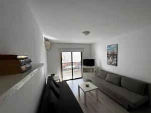 a living room with a couch and a table at Theodoros Apt.79 in Paralimni