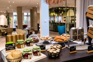 a bakery with a variety of pastries on display at Motel One Frankfurt-Hauptbahnhof in Frankfurt