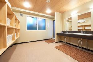 a bathroom with a sink and a large mirror at Select Inn Fujisan Gotemba in Gotemba
