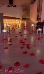 a bunch of red rose petals on a table at Escale Cosy à Villeneuve in Villeneuve-la-Garenne