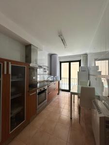 a kitchen with a table and a dining room at Piso Ría de Ribadeo in Ribadeo