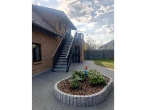 a building with a planter in front of a house at FeWo Wolfsbau ID 16290-9 in Kargow