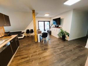 an apartment with a kitchen and a living room at FeWo Wolfsbau ID 16290-9 in Kargow +15 photos