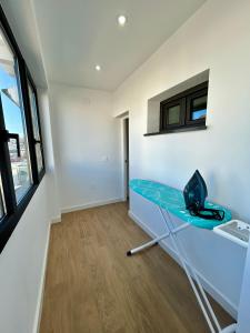 a room with a blue table and a window at Center Luxury Chalet Mazagón in Mazagón