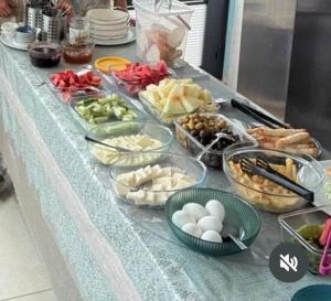 a table topped with plates and bowls of food at Harmony Blue Pansiyon in Burhaniye +30 photos