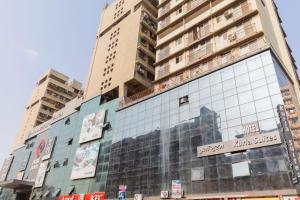 a tall building with a sign on the side of it at Hotel Kurla Suites in Mumbai