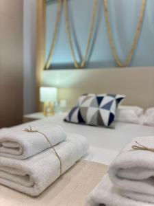 a hotel room with towels on a bed at Green Suite Skiathos in Skiathos