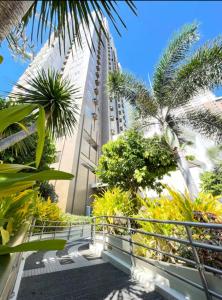 a walkway with palm trees and a tall building at The Suite Pod I CDO CondoStaycation - U26 in Cagayan de Oro