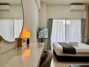 a small bedroom with a bed and a mirror at Lion Heiwa Odori in Hiroshima
