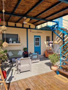a patio with a blue railing and a blue staircase at בין צבעי החול in Sappir