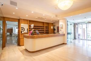 a lobby with a reception desk in a building at Hotel L'Approdo in Castiglione della Pescaia