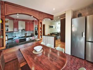 an open kitchen and dining room with a wooden table in a house at Casa Migjorn in Valls de Torroella