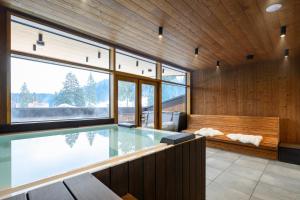 a swimming pool in a room with wooden walls at Flora Boutique Hotel in Borovets