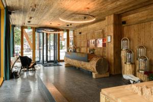 a room with wooden walls and a table and chairs at Flora Boutique Hotel in Borovets