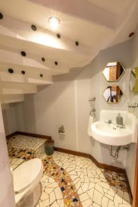a bathroom with a toilet and a sink at Casa Historica Atitlán in Panajachel +19 photos