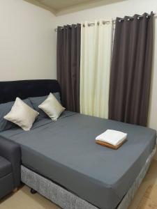 a bed with two pillows on it in a room at The Suite Pod I CDO CondoStaycation - U26 in Cagayan de Oro +24 photos