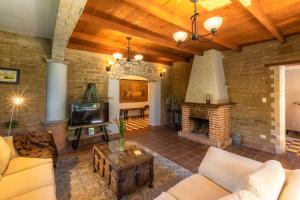 a living room with a brick wall and a fireplace at Casa Historica Atitlán in Panajachel