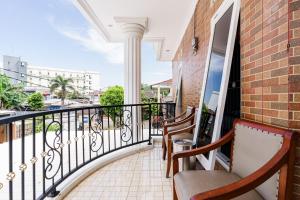 a balcony with chairs and a view of a city at Fast Hous Syariah Bogor Mitra RedDoorz in Bogor