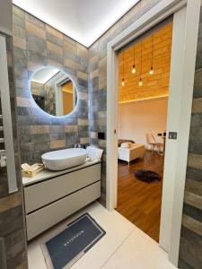 a bathroom with a sink and a mirror at La Neviera Apulia Rooms in Altamura