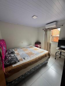 a bedroom with a bed and a window and a television at Casa Saltos del Guiara in Salto del Guairá
