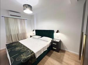 a bedroom with a bed with a black and white blanket at Apartment San Pietro in Supetar