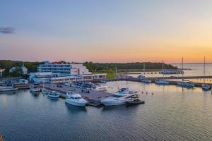 a group of boats docked at a marina at sunset at Terrasstudion - Borgholm in Borgholm +5 photos