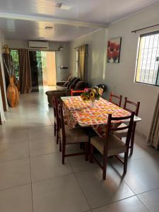 a table and chairs in a living room with a couch at Casa Saltos del Guiara in Salto del Guairá +1 photo