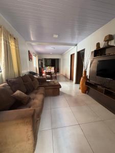 a living room with a couch and a tv at Casa Saltos del Guiara in Salto del Guairá