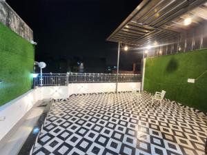 a balcony with a green wall and a bench at The Trishul Stay in Varanasi
