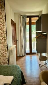 a bedroom with a bed and a sliding glass door at Leyendas Del Pirineo Turismo Rural in Fiscal
