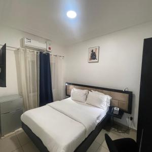 a bedroom with a bed with white sheets at SOFT HOTEL in Douala +25 photos