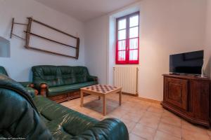 a living room with a couch and a coffee table at Ecluse d'Aiguilly in Alluy