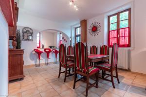 a dining room with a table and red chairs at Ecluse d'Aiguilly in Alluy +10 photos