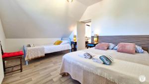 a room with two beds and a chair in it at Ecluse d'Aiguilly in Alluy