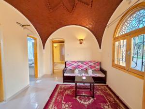 a living room with a couch and a table at Talia gust house in Al Aqālitah +28 photos