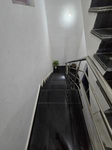 a staircase in a building with a stair case at Parth Guest House in Ayodhya