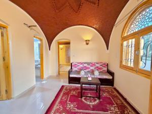 a living room with a couch and a table at Talia gust house in Al Aqālitah