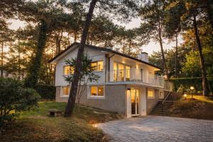 a large white house with a lot of windows at Villa Greif Apartment in Lignano Sabbiadoro