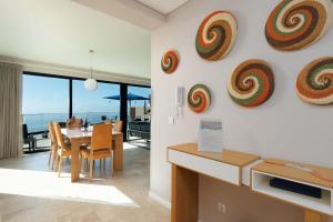 a dining room with a table and some artwork on the wall at Elísio do Mar by LovelyStay in Prazeres