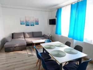 a living room with a table and a couch at Diana Panzió in Mátrafüred