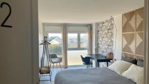 a bedroom with a bed and a desk and a window at Rivéa Bizy - Villa 150m2 - 2ou5 CH - 2 SDB - Parking Wifi in Vernon