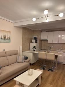a living room with a couch and a kitchen at Isabella in Roquetas de Mar