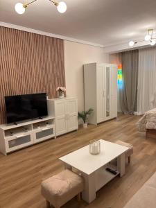 a living room with a television and a table at Isabella in Roquetas de Mar