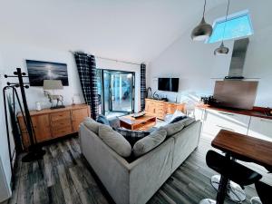 a living room with a couch and a table at Ferndown Holiday Let in Ferndown