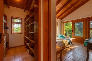 a bedroom with a bed and a book shelf at Casa Tropical Atitlán in Panajachel