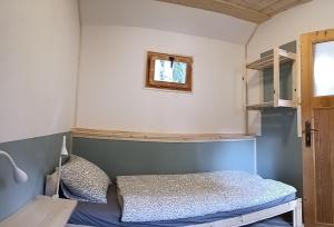 a small bedroom with a bed and a window at Pravda in Loket +6 photos