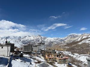 a city in the snow with mountains in the background at The face resort in Muktināth
