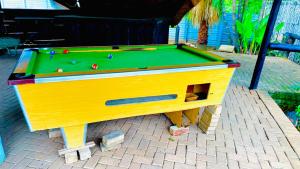 a pool table sitting on top of a brick ground at Fourways Luxury Residence in Four Ways